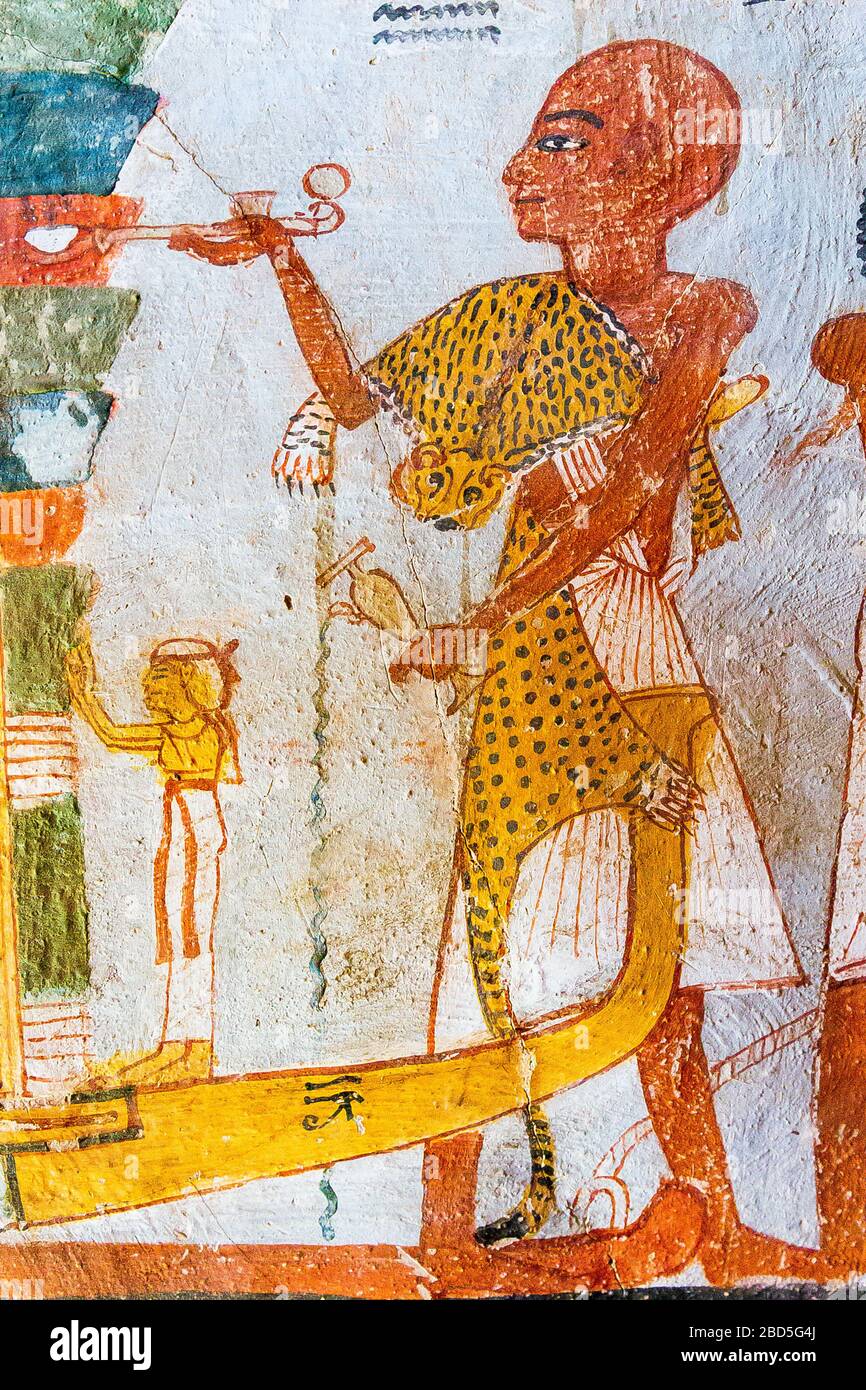 UNESCO World Heritage, Thebes in Egypt, Valley of the Nobles (Dra Abu el Naga), tomb of Roy. A priest wearing a panther skin. He pours a libation . Stock Photo