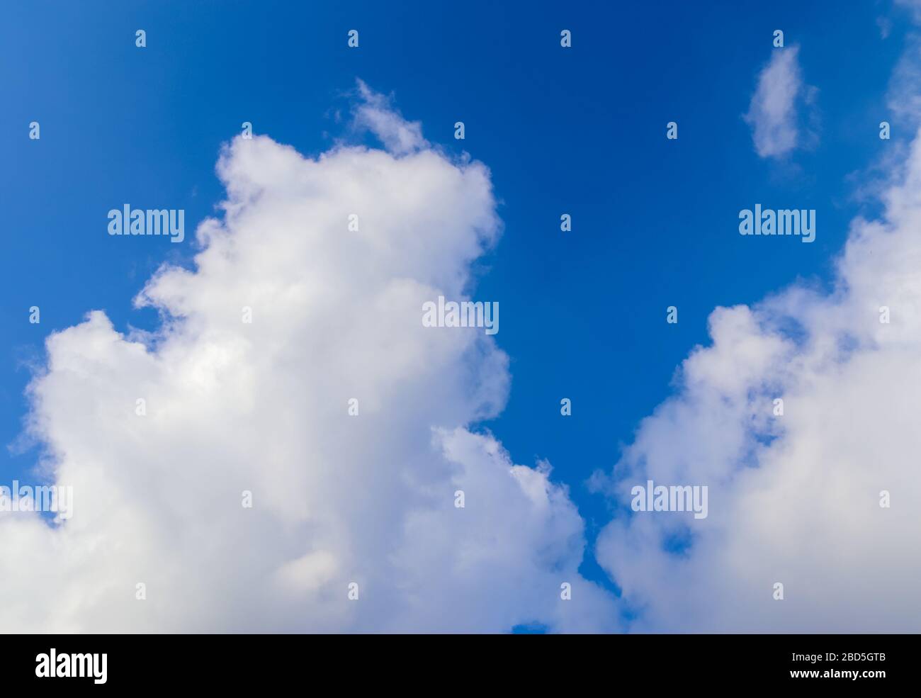 Beautiful white fluffy clouds in a deep blue summer sky Stock Photo - Alamy
