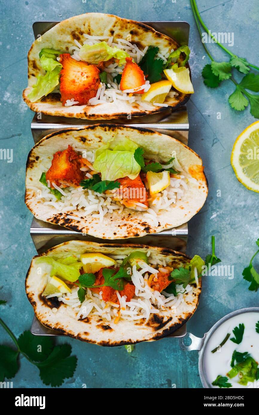 Homemade Chicken Tikka Tacos served in a metal Taco stand, selective focus Stock Photo