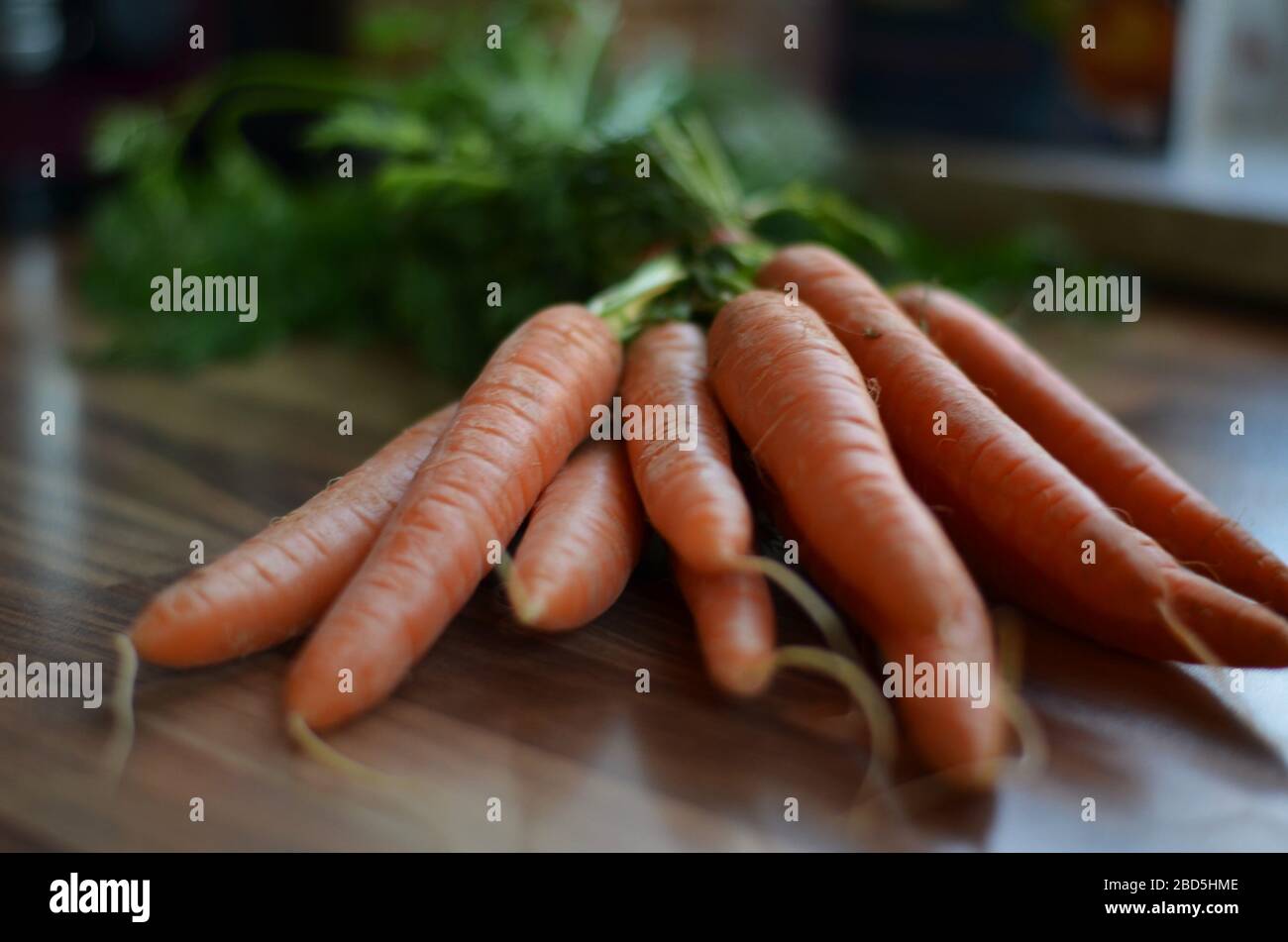 orange carrots on a table in the kitchen Stock Photo