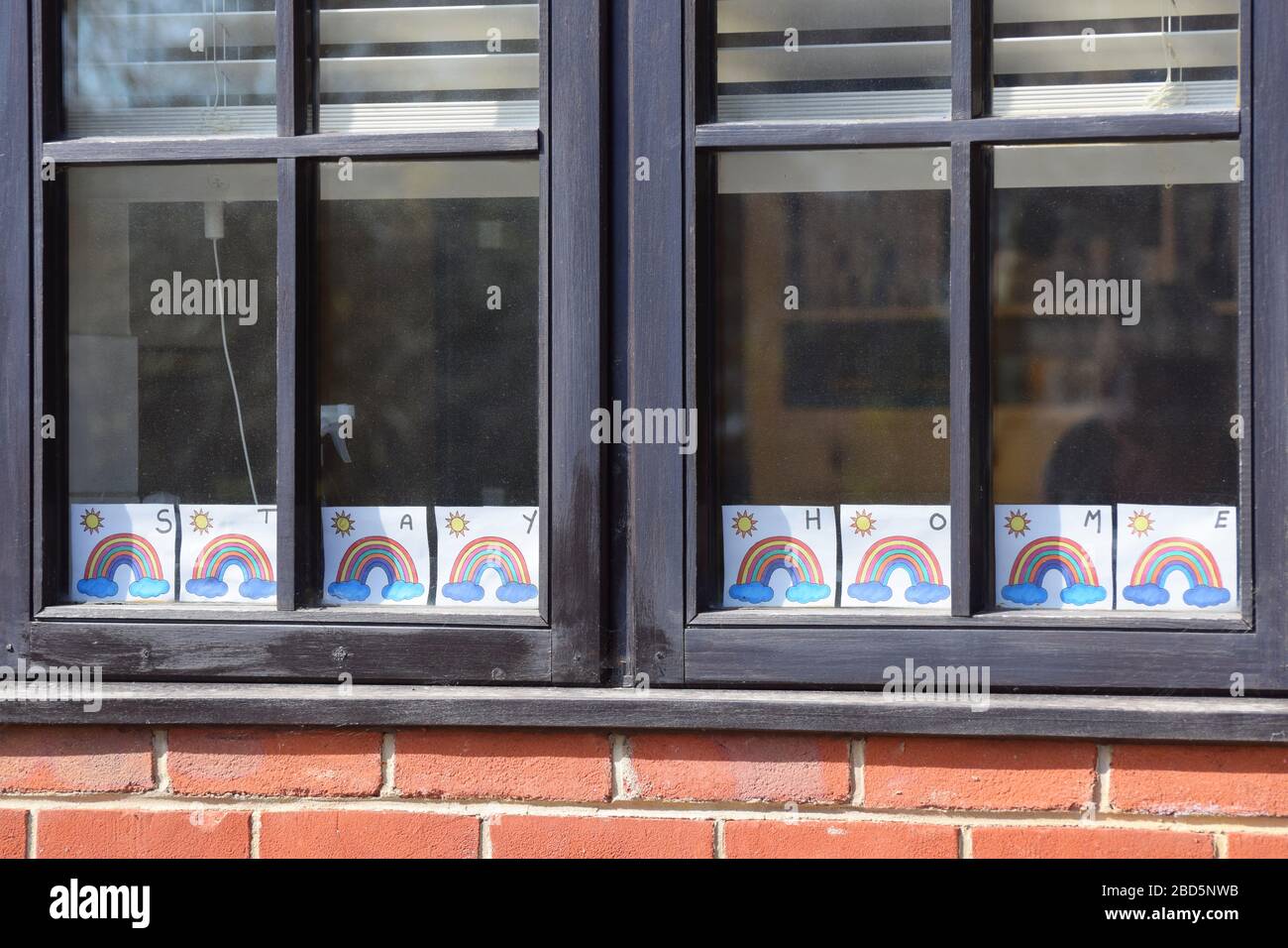 Rainbow pictures for hope and positivity with the message "Stay Home" displayed in the house in the UK during the Coronavirus Covid-19 lockdown Stock Photo
