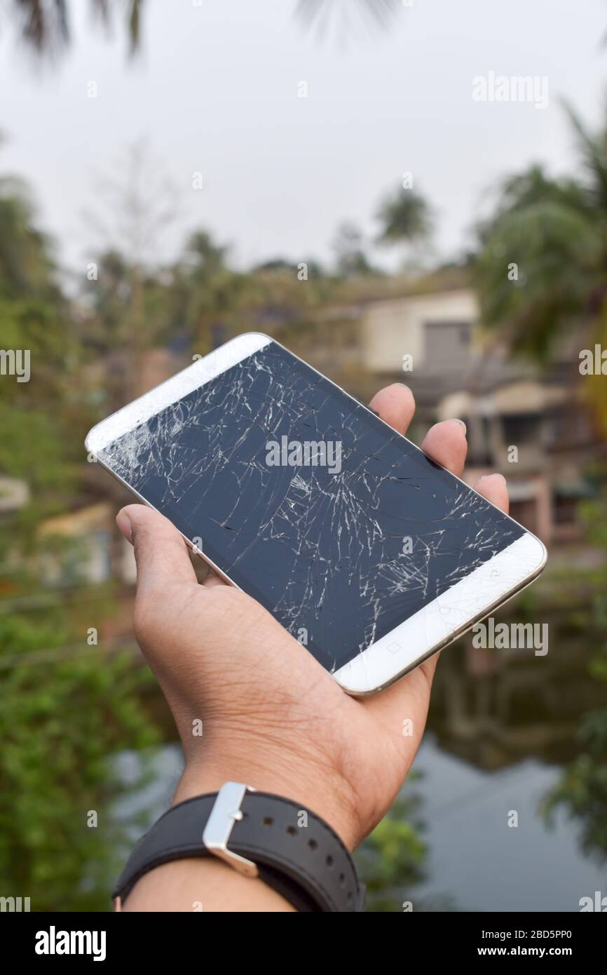 Broken device screen of a mobile phone. Cracked touch screen of digital