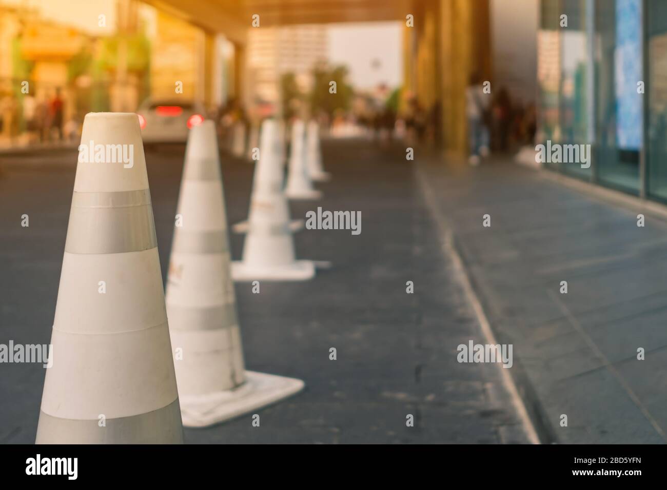 The white traffic cones are set up as a pedestrian safety zone in front