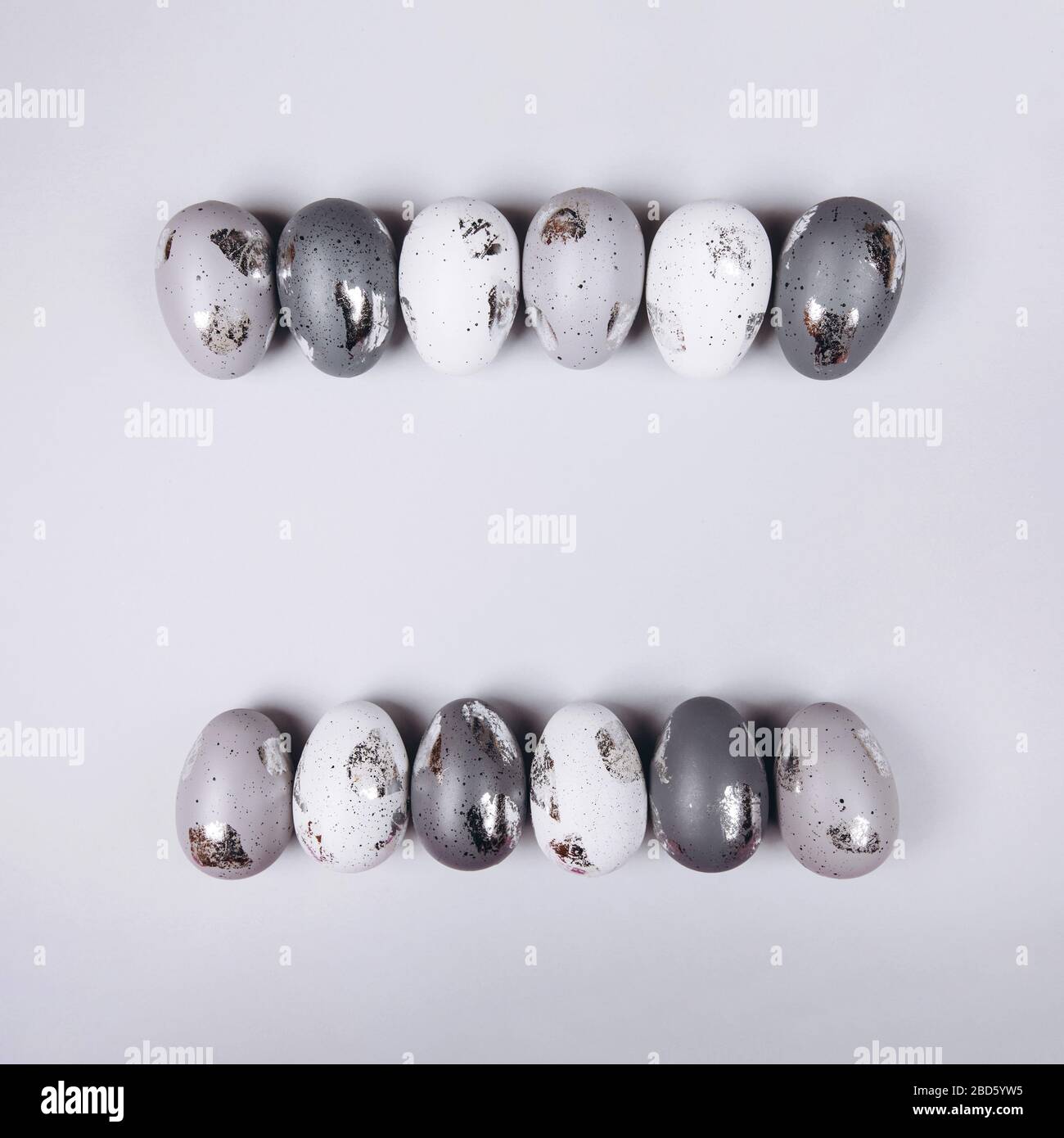 Easter eggs in two rows on grey background. copy space. Stock Photo