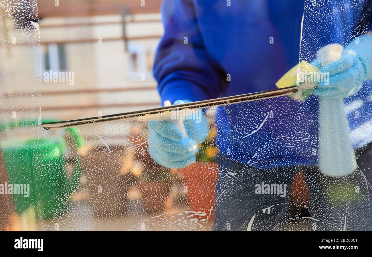 housekeeping cleaning the windows, Window cleaner using a squeegee