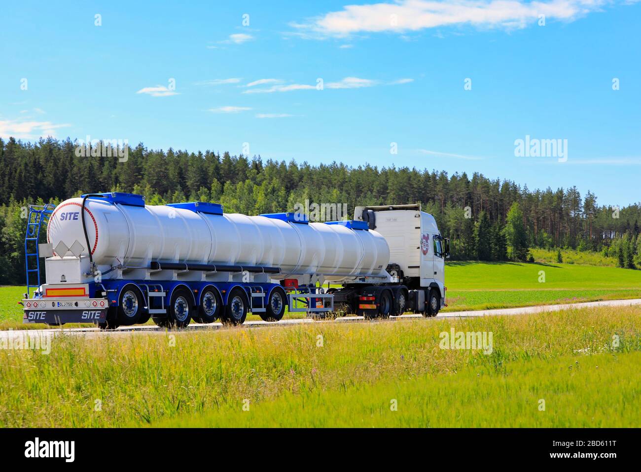 White Volvo FH truck with 5-axle tank semi-trailer on the way to pick up load on summer highway, side view. Salo, Finland. July 6, 2019. Stock Photo