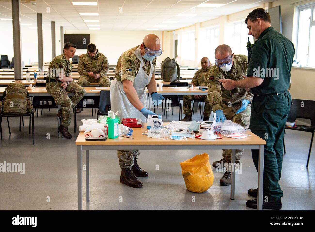 Members of the British Army learn how to apply PPE during training to support the Welsh Ambulance Service NHS Trust (WAST) in the battle against COVID-19 at the Sennybridge Training Camp in Mid Wales. Stock Photo