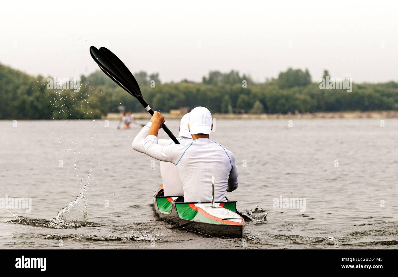 back two kayakers paddling kayak in competition race Stock Photo