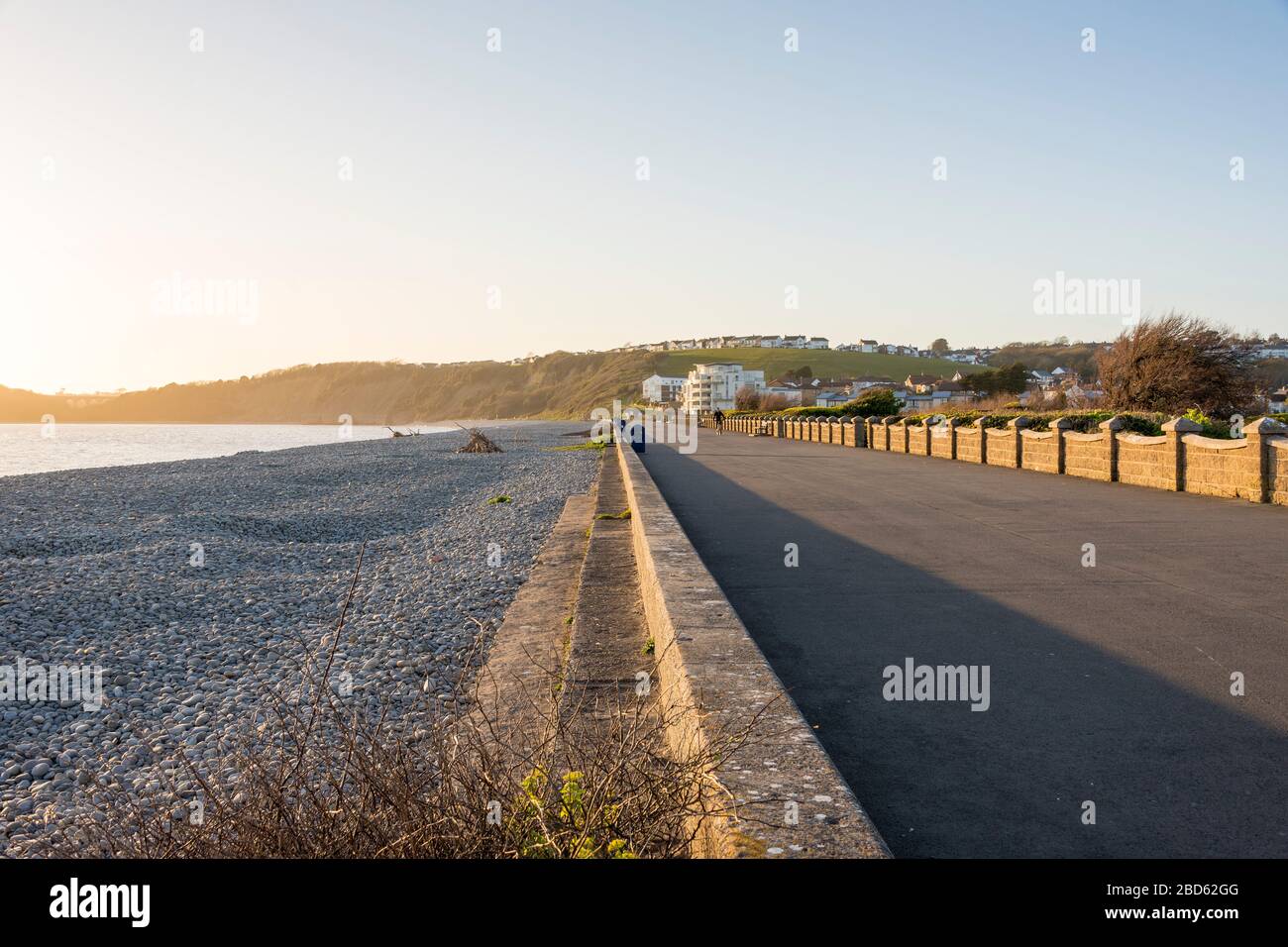 On a beautiful sunny evening the promenade at The Knap beside the pebble beach is virtually deserted during the Covid-19 crises. Stock Photo