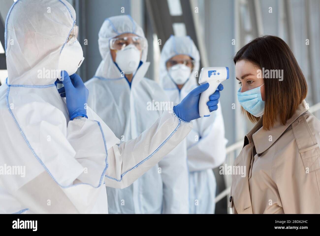 Medical worker organize check point for measuring temperature Stock Photo