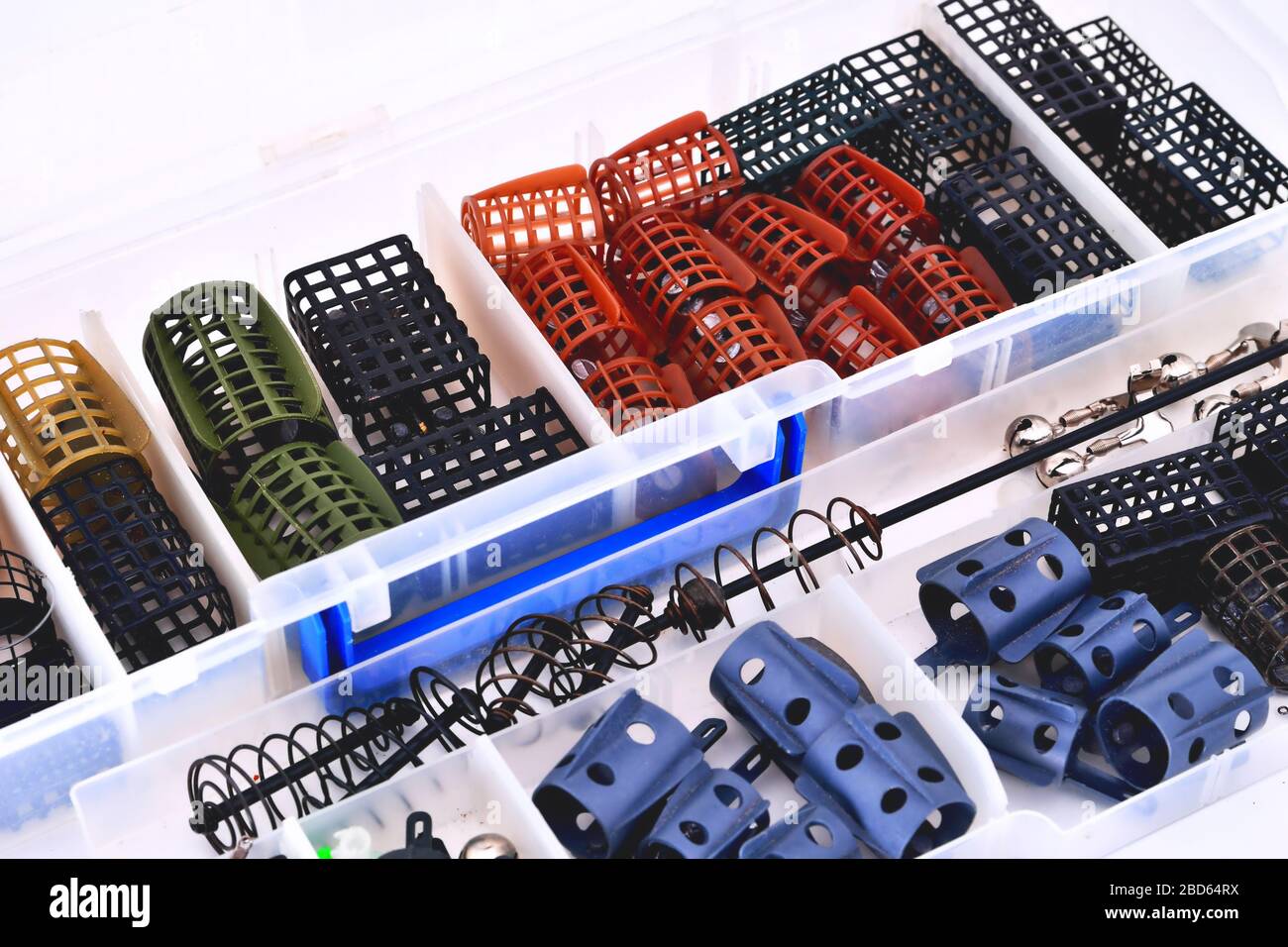 Feeder troughs of different colors and sizes in a plastic box for accessory close-up Stock Photo
