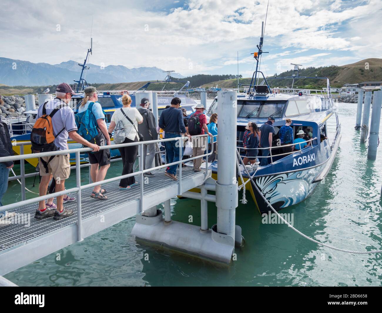 Tourists boarding the boat Aoraki on a whale watching trip in Kaikoura New Zealand Stock Photo