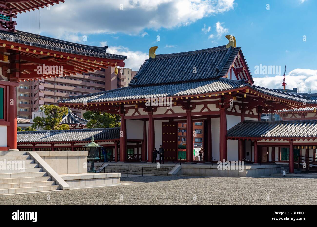 A picture of the Shitenno-ji Temple, namely one of its gates, as seen from inside the premises of the temple. Stock Photo