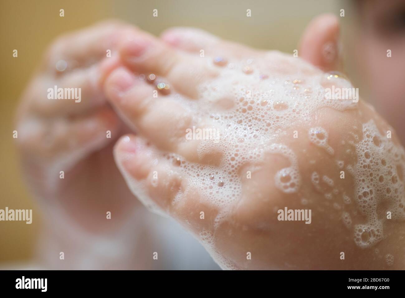 Hand of Bathing Child in Soap Bubbles Stock Photo