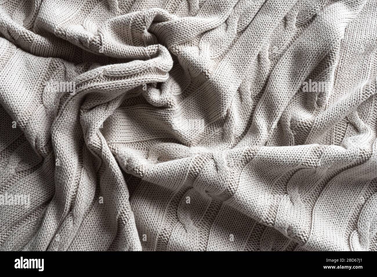 Texture gray knitted fabric with a pattern. Stock Photo
