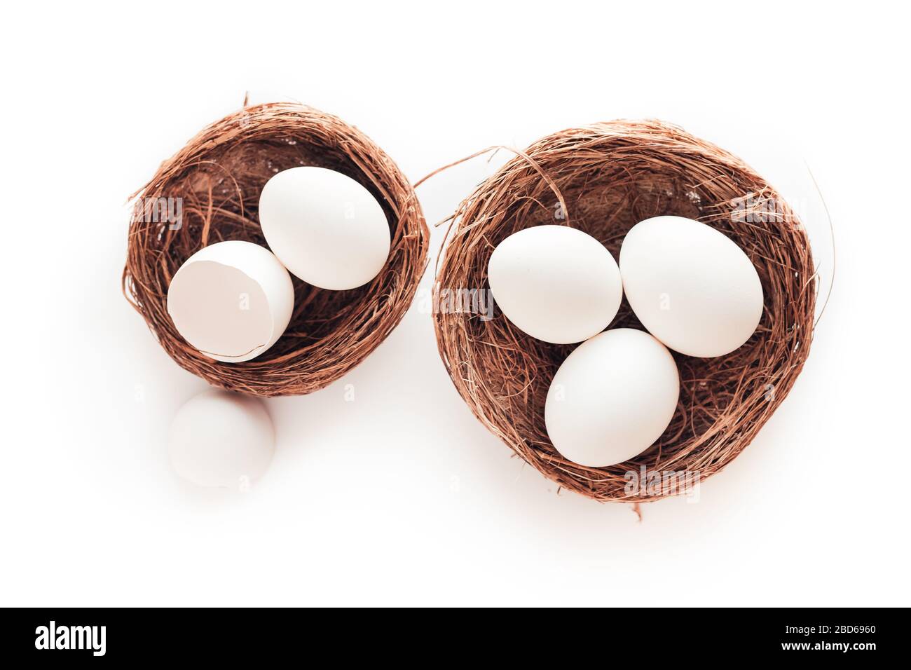 Two nests with hen eggs isolated on white background Stock Photo - Alamy