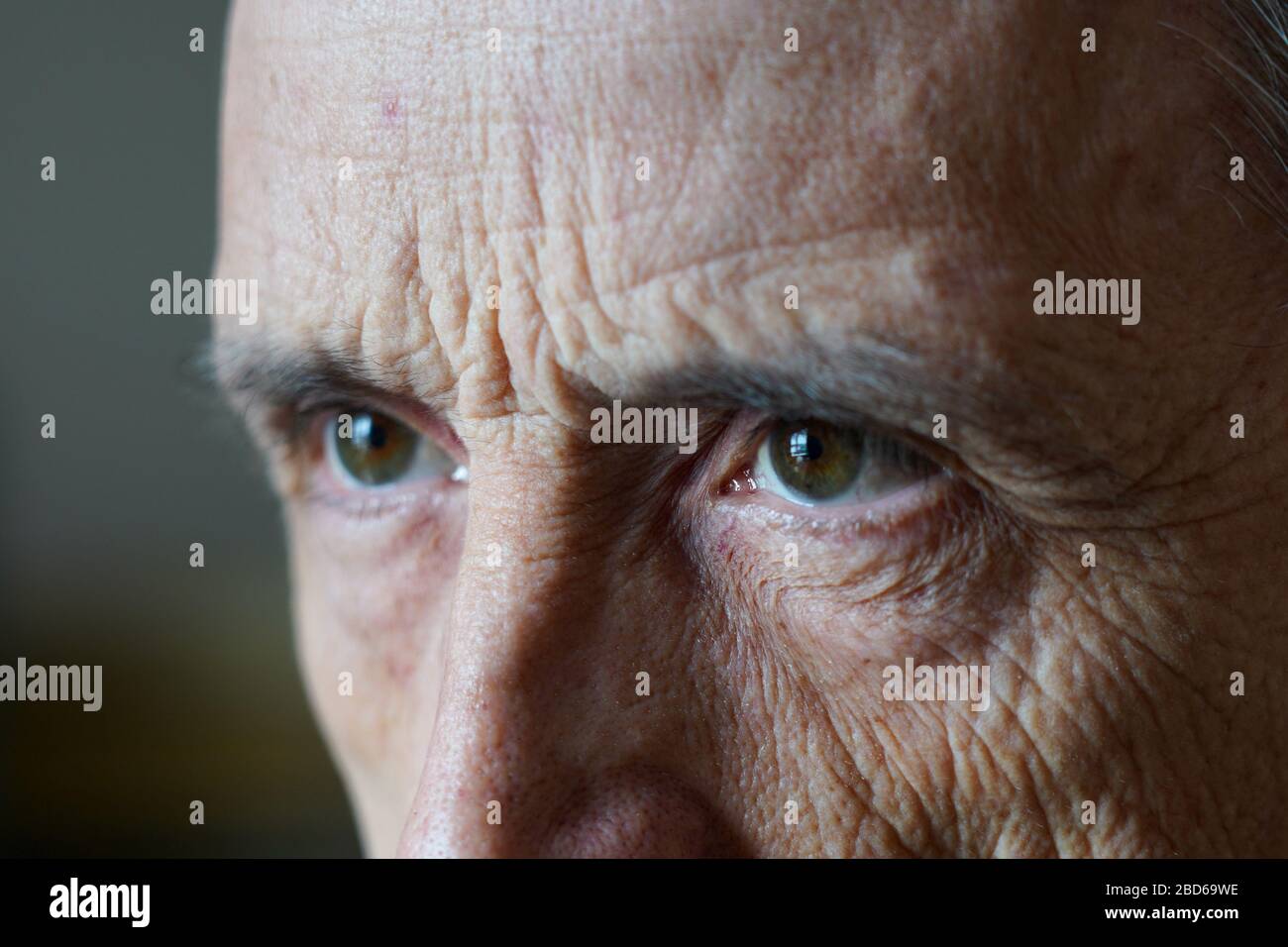 Eyes of a man close-up. A mature man frowns aside Stock Photo