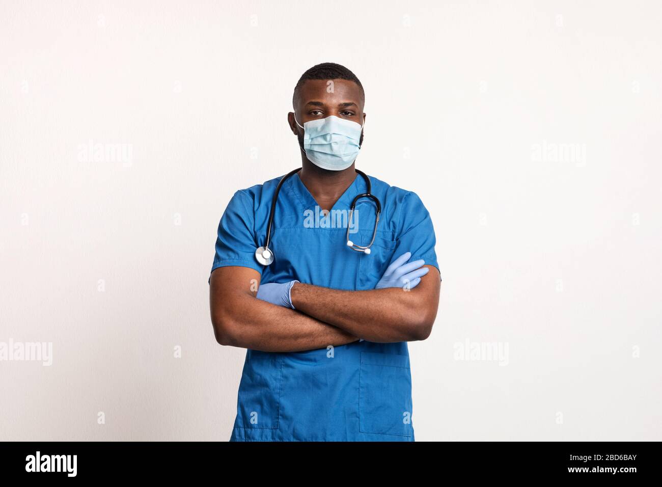 Confident black doctor in face mask and gloves over white Stock Photo ...