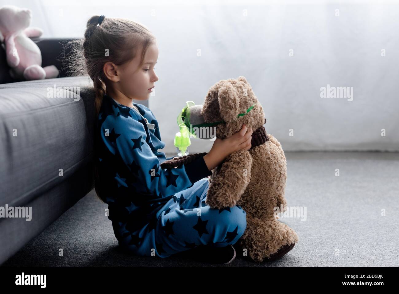 profile of cute kid holding teddy bear in respiratory mask Stock Photo ...