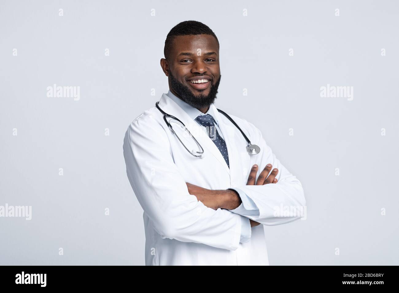 Confident black doctor posing over white studio background Stock Photo ...
