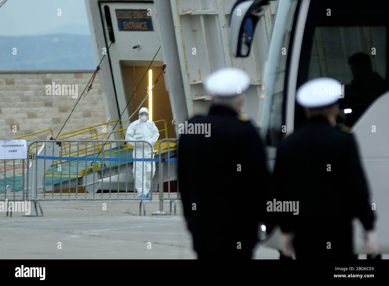 Member of the medical team (left) in the entrance of El. Venizelos ship. (Photo by Dimitrios Karvountzis/Pacific Press) Stock Photo
