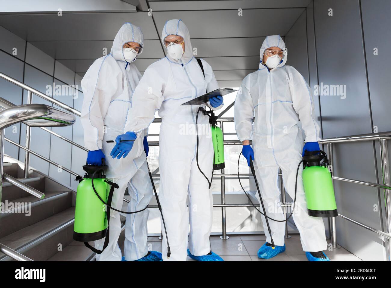 Virologists making professional cleaning with disinfectant spray Stock
