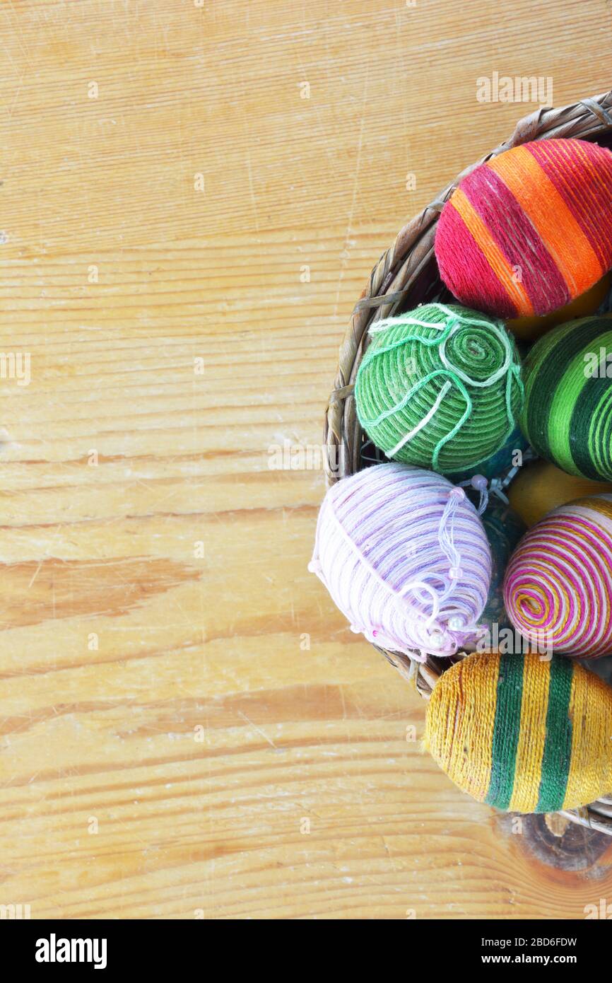 Eggs decorated with threads on wooden  table Stock Photo
