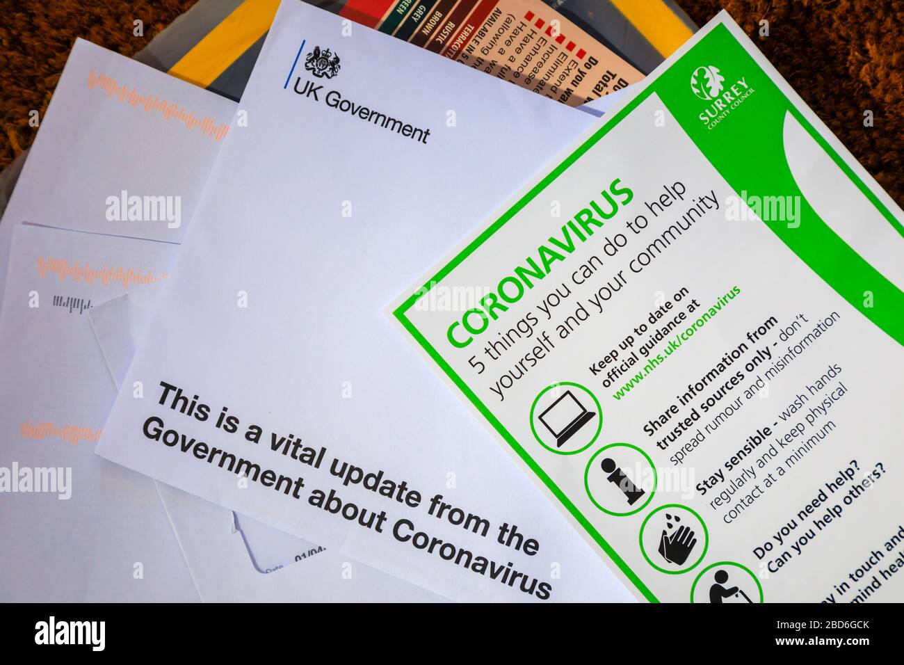 Coronavirus pandemic: advice and instructions from the UK Government delivered by post arrive at every home with a leaflet from Surrey County Council Stock Photo