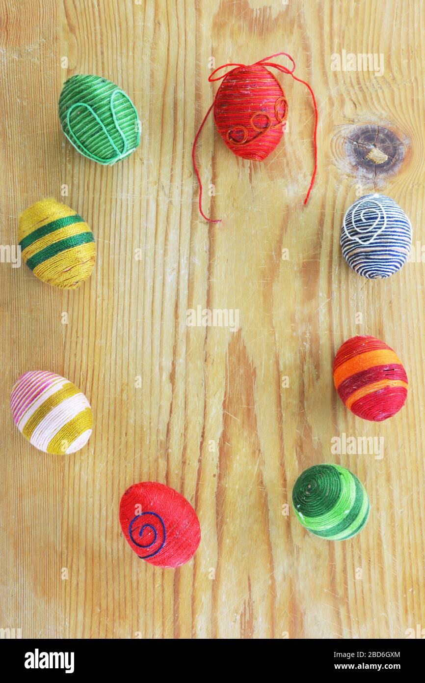 Eggs decorated with threads on  rustic wooden  table Stock Photo