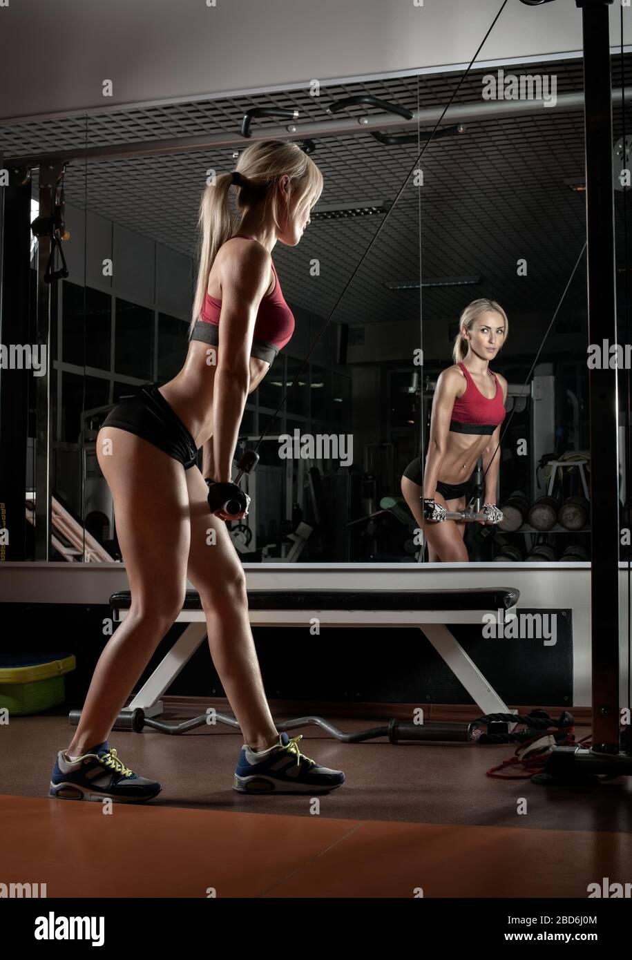beautiful woman bodybuilder in dark GYM , fitness concept, vertical photo Stock Photo