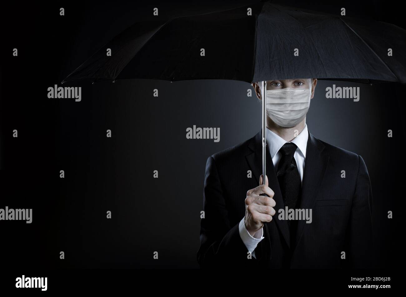 man in medical mask on face with umbrella, concept coronavirus covid-19 epidemic Stock Photo