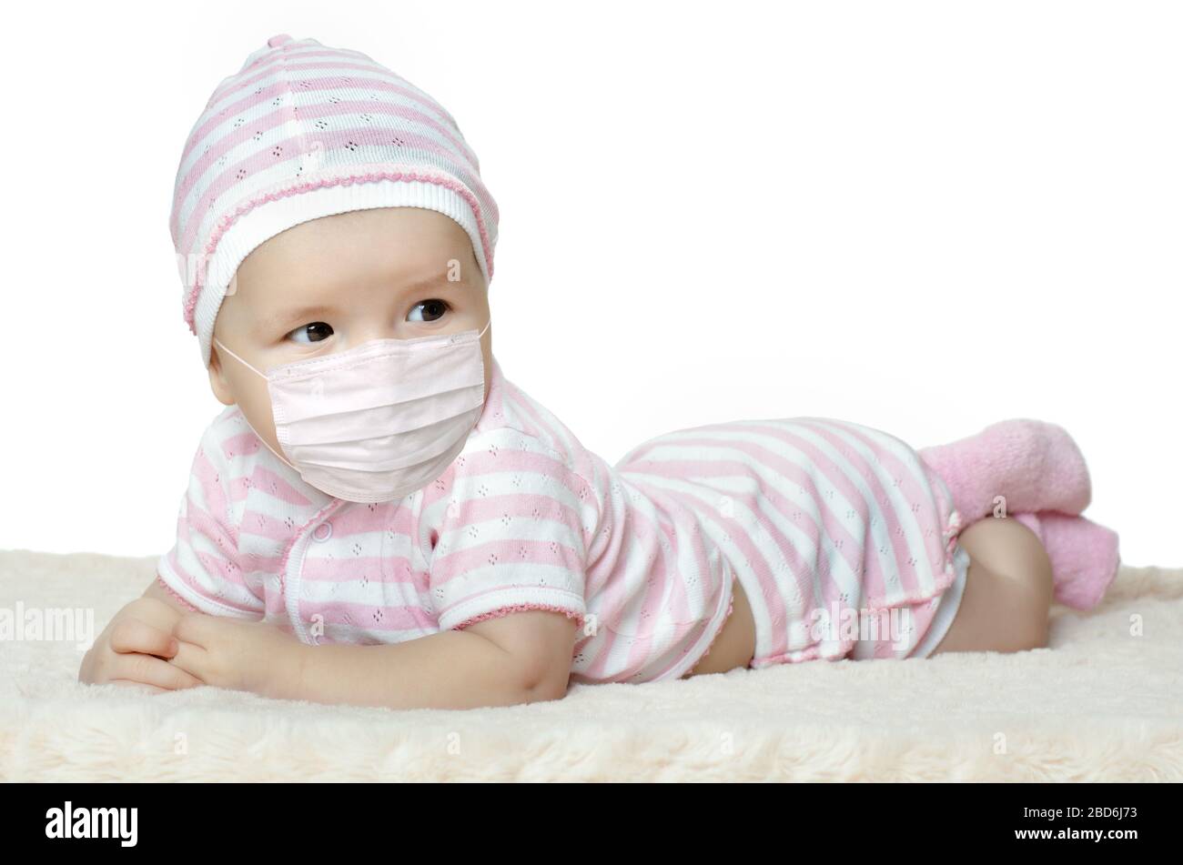 little baby in medical mask, on white background, isolated. Concept covid-19 coronavirus pandemic Stock Photo