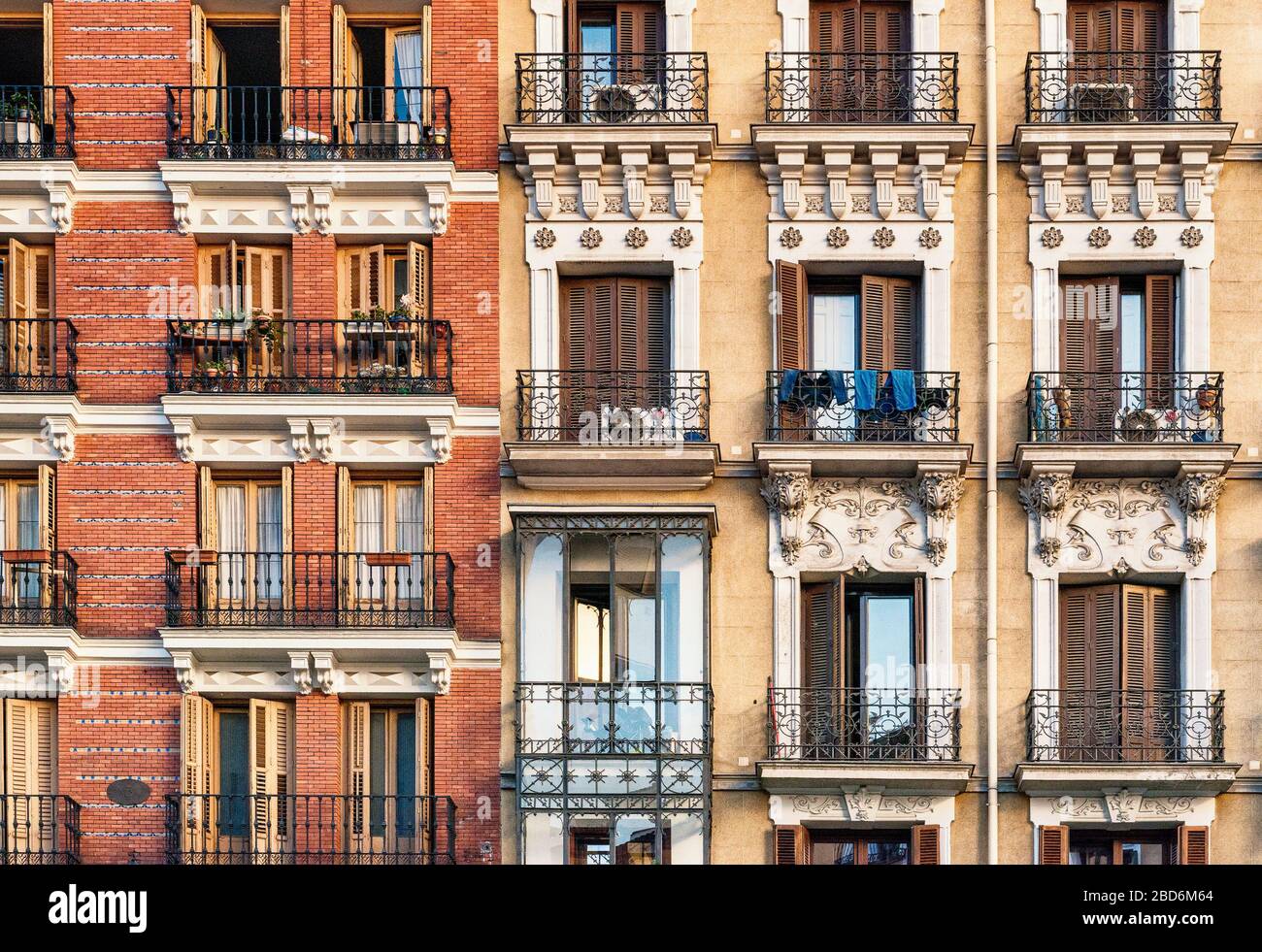 Looking up at elegant assorted shuttered balconies on the side of a period building Stock Photo