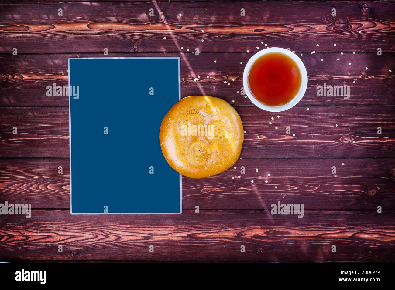 Traditional tandyr bread of Central Asia with tea on a wooden background with place for text. Top view Stock Photo