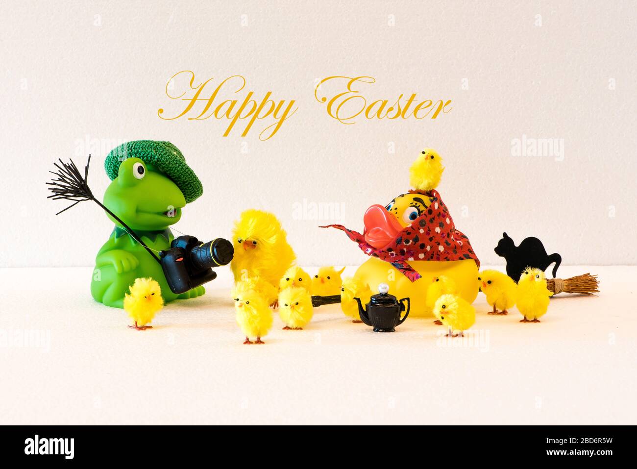 A Happy Easter greeting card with the Easter Duck and Photographer Frog with all their chickens Stock Photo