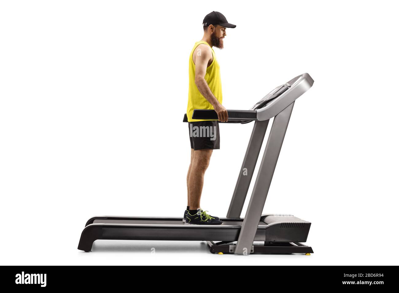Full length shot of a bearded man on a treadmill isolated on white background Stock Photo