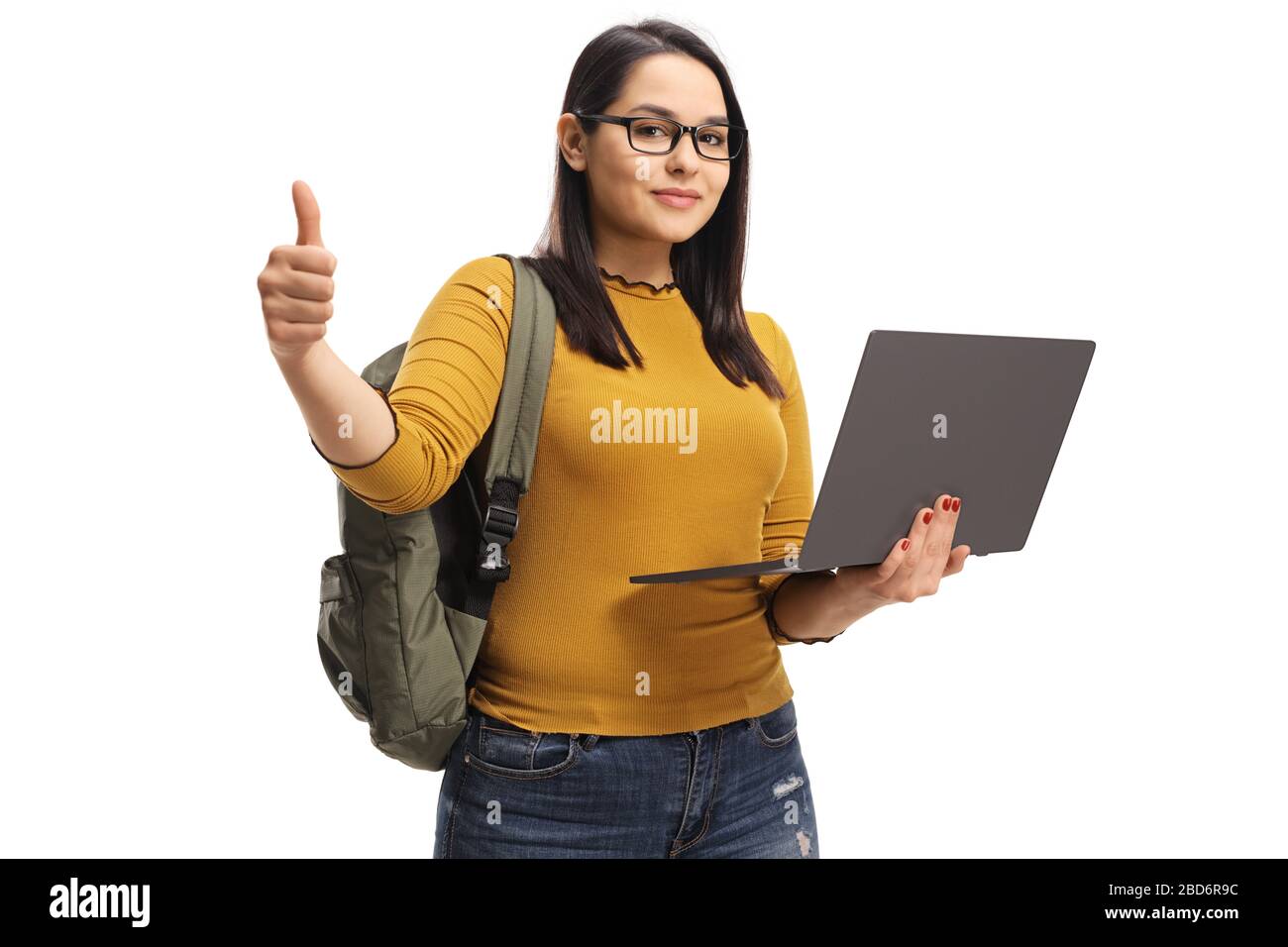 Female student holding a laptop computer and showing thumbs up isolated ...