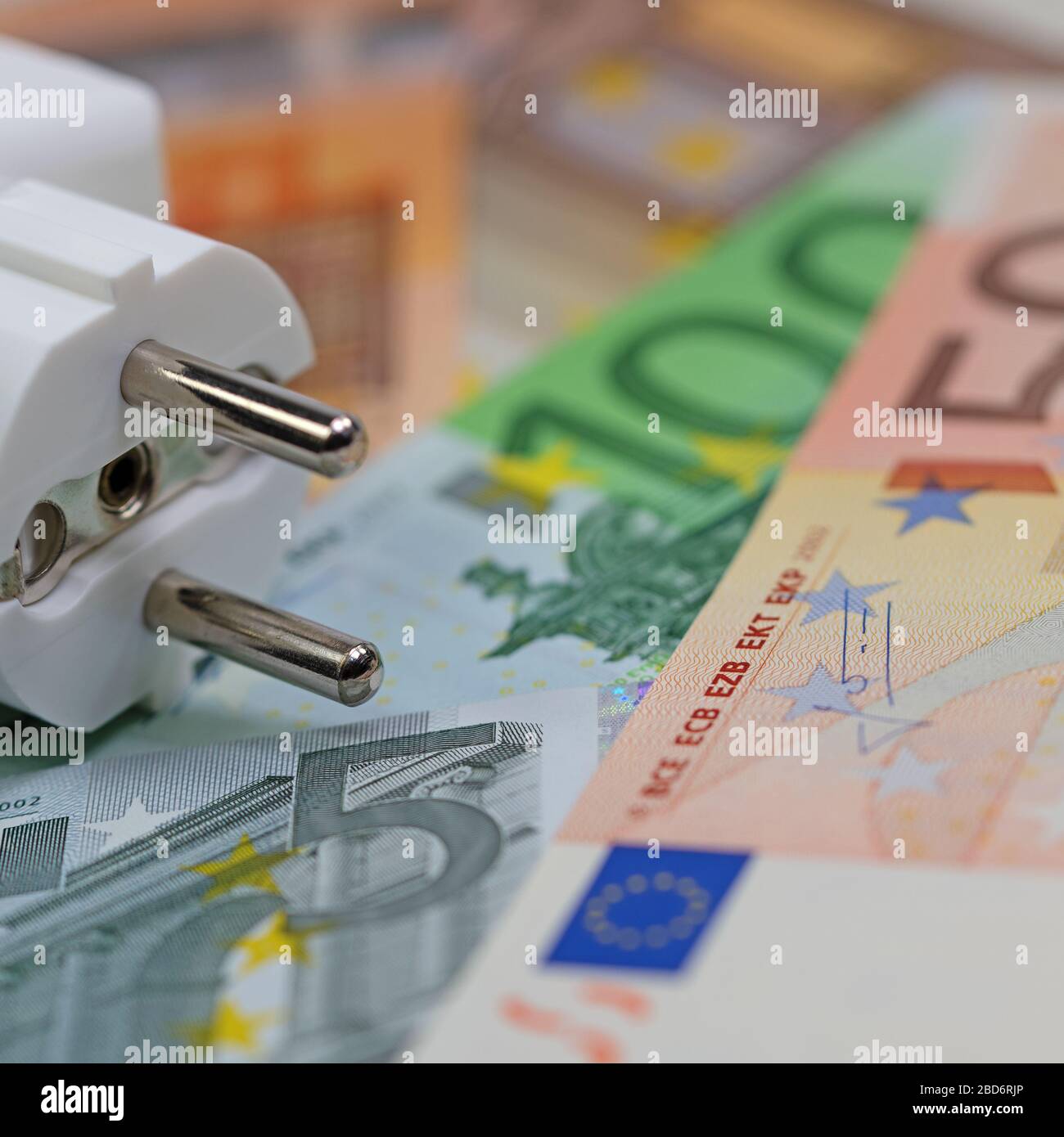 Banknotes and power plug symbolic of electricity price Stock Photo