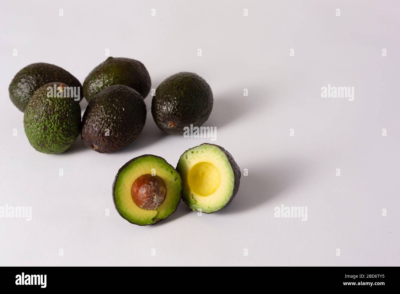 Whole and sliced avocados on white background Stock Photo - Alamy