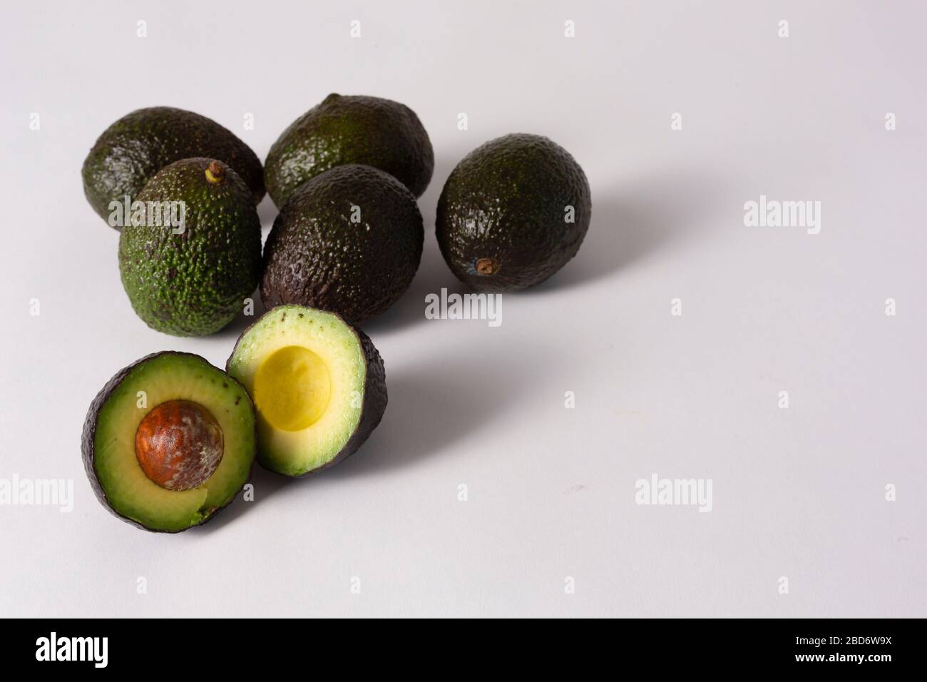Whole and sliced avocados on white background Stock Photo - Alamy