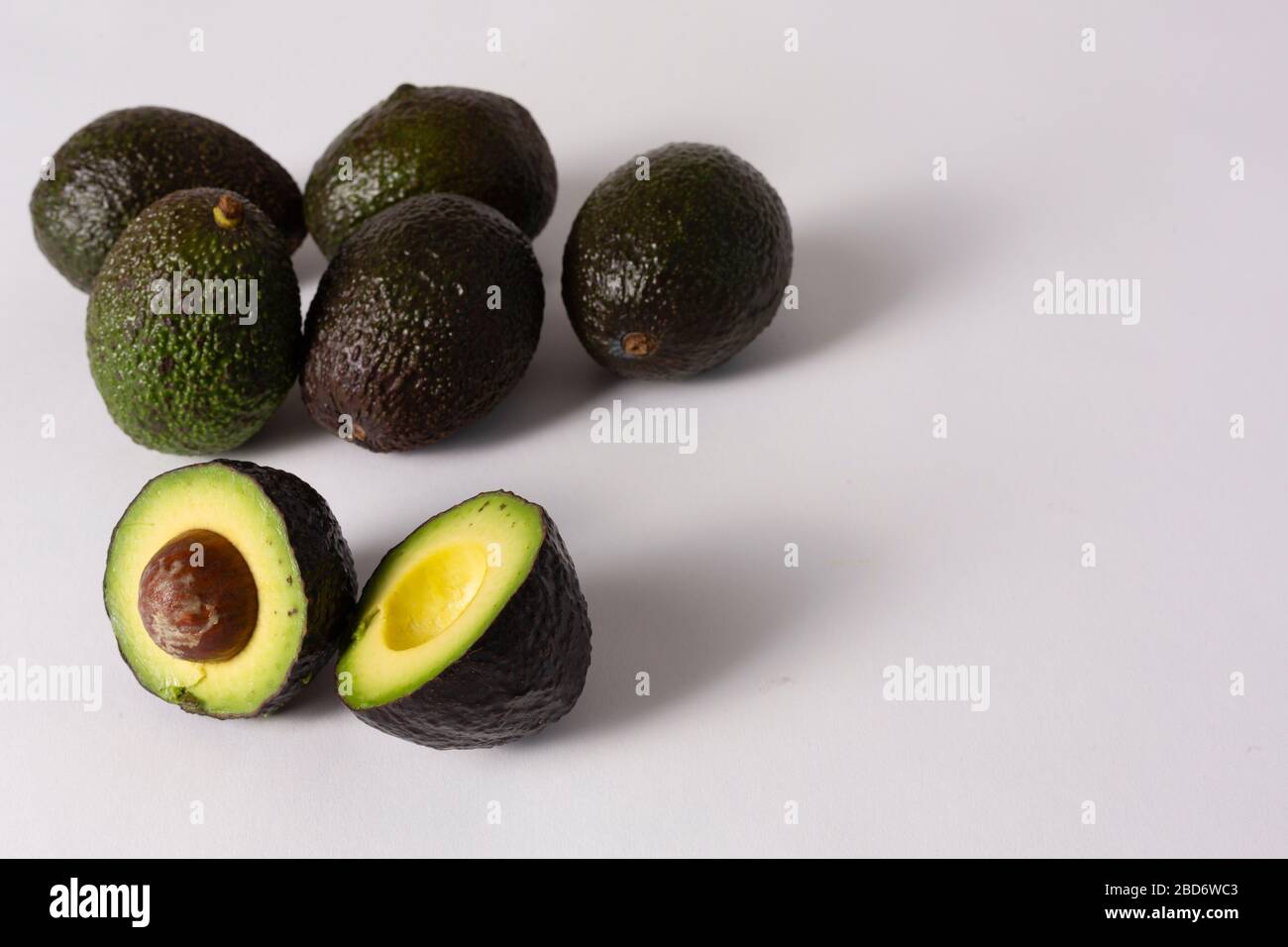 Whole and sliced avocados on white background Stock Photo - Alamy