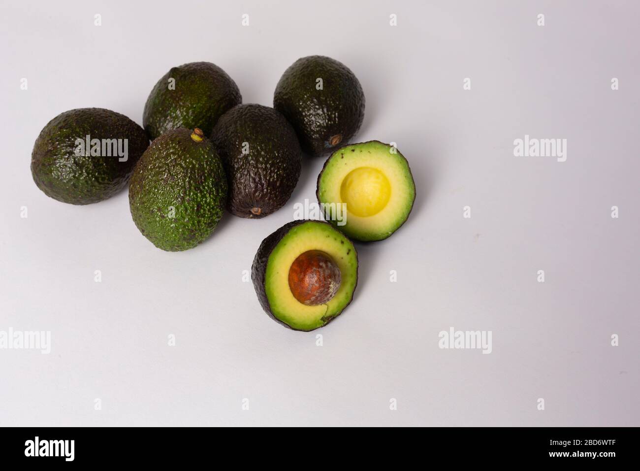 Whole and sliced avocados on white background Stock Photo - Alamy