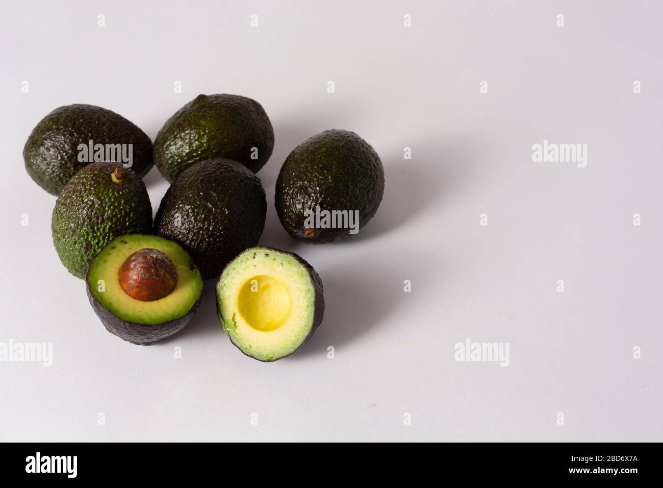 Whole and sliced avocados on white background Stock Photo - Alamy