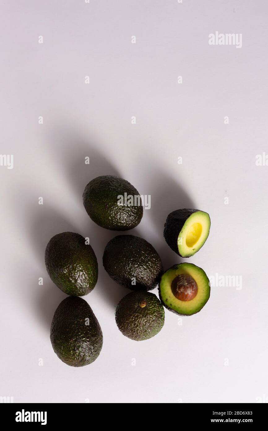 Whole and sliced avocados on white background Stock Photo - Alamy