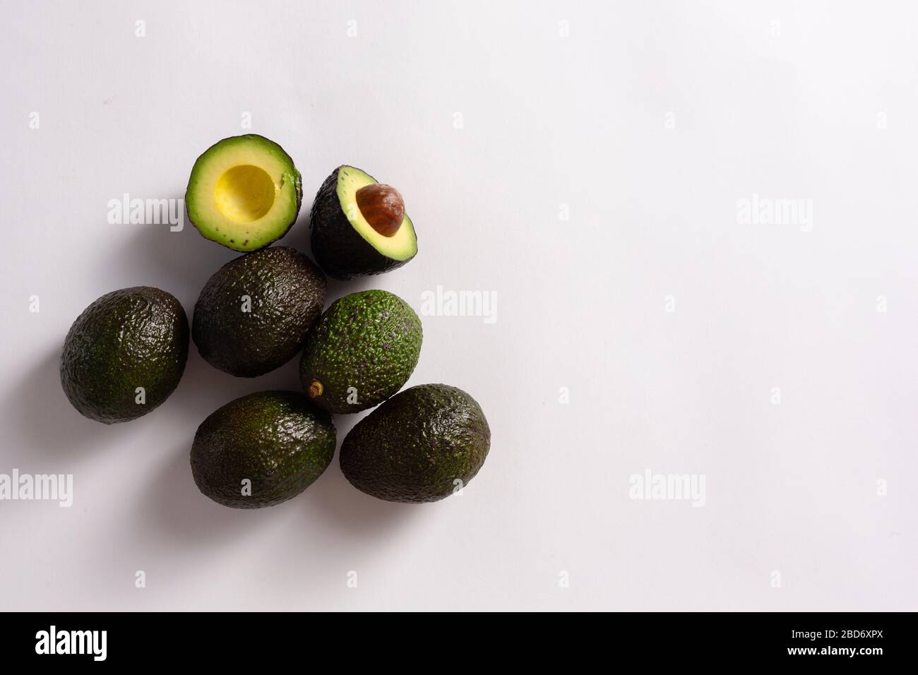 Whole and sliced avocados on white background Stock Photo - Alamy