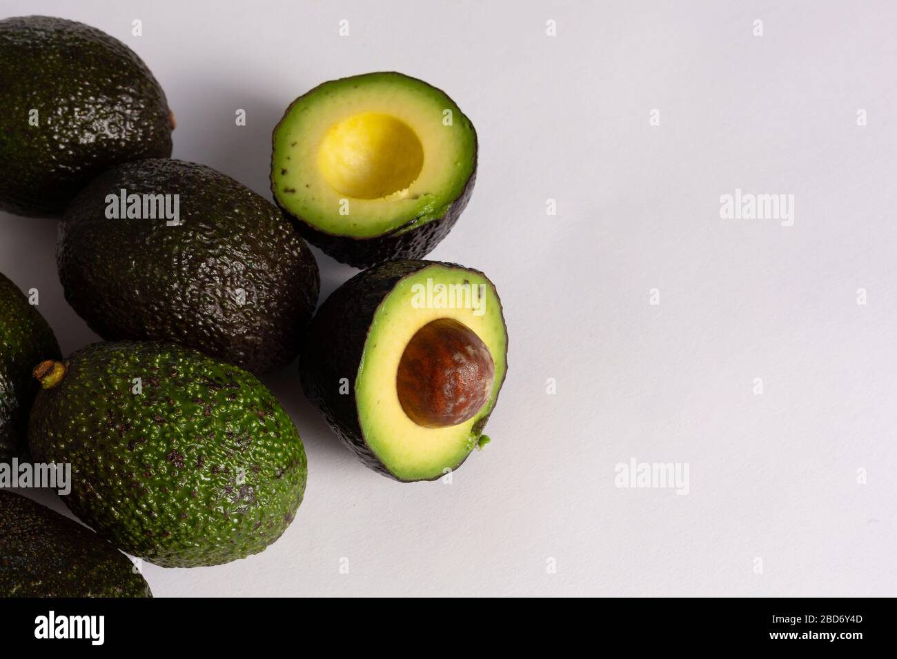 Whole and sliced avocados on white background Stock Photo - Alamy