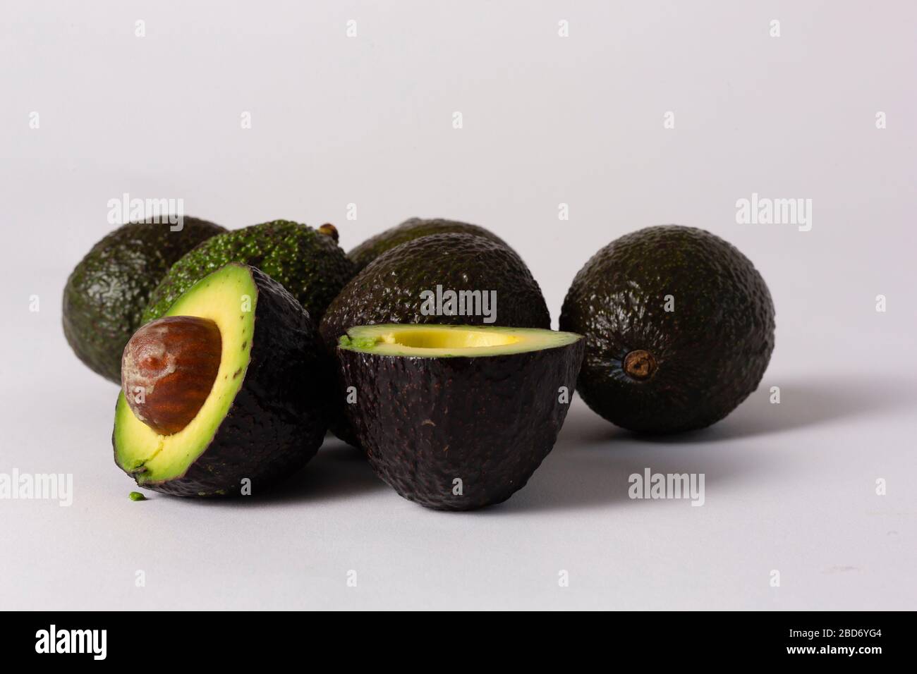 Whole and sliced avocados on white background Stock Photo - Alamy