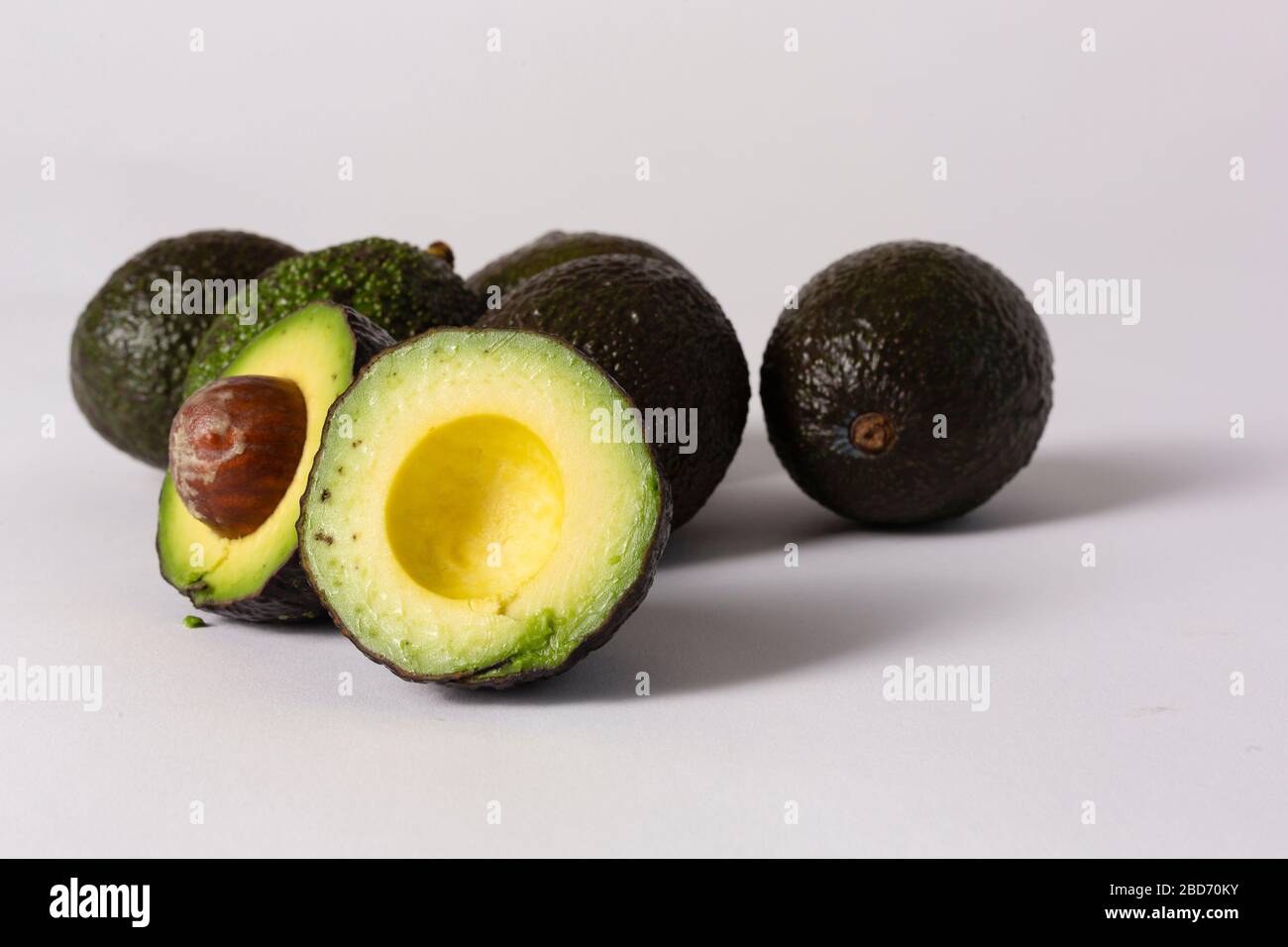 Whole and sliced avocados on white background Stock Photo - Alamy