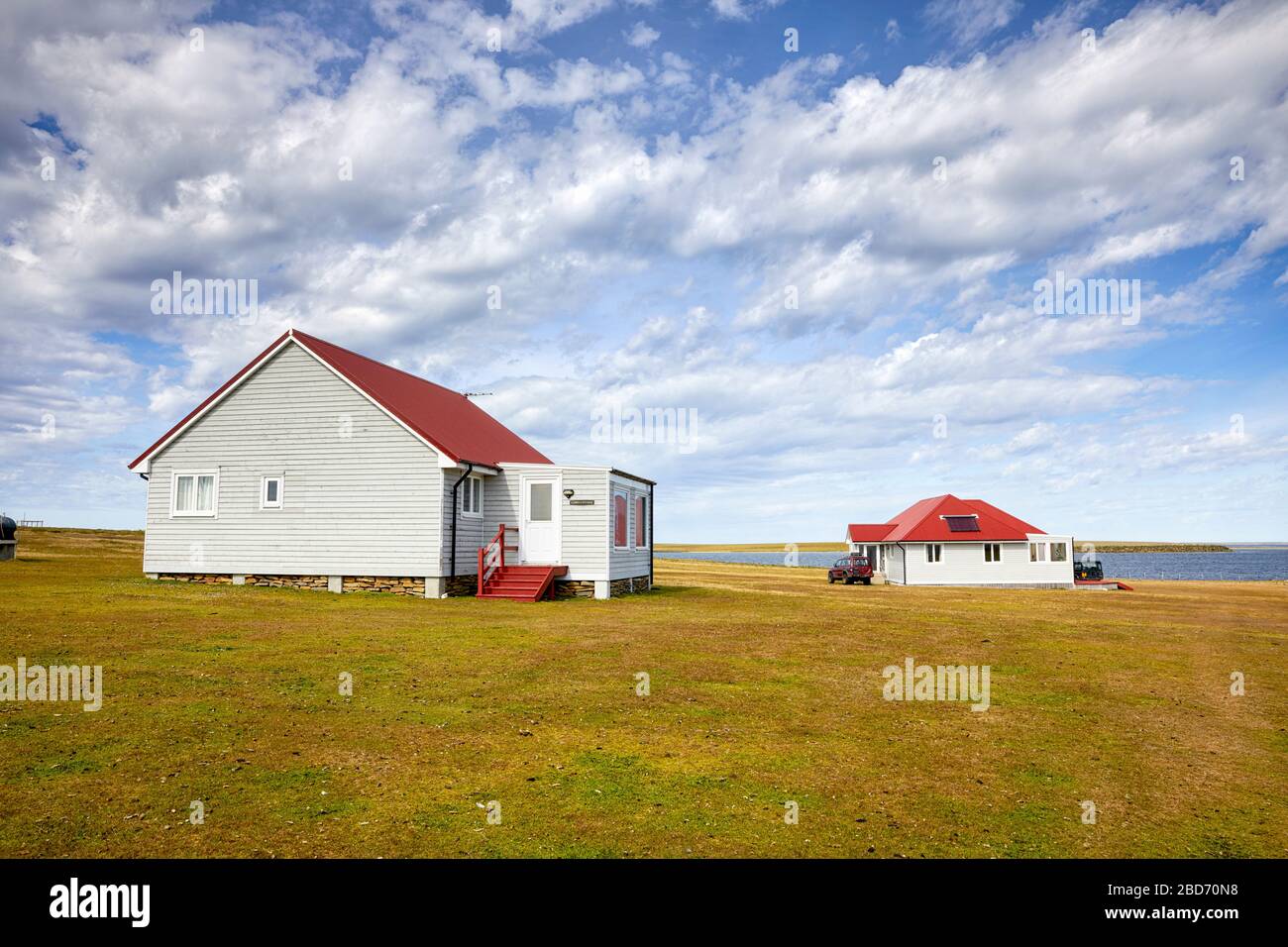 Cobb’s Cottage and Guest house in the background (tourist accomodation) on Bleaker Island, Falkland Islands, Falklands Stock Photo