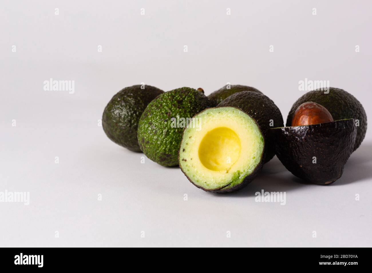 Whole and sliced avocados on white background Stock Photo - Alamy